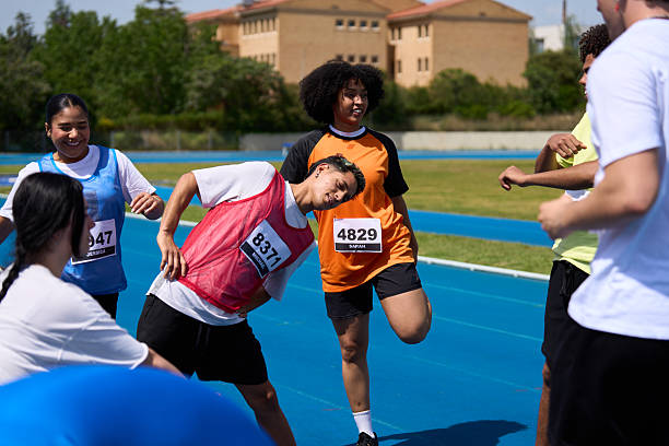Athletes stretching together before a track race