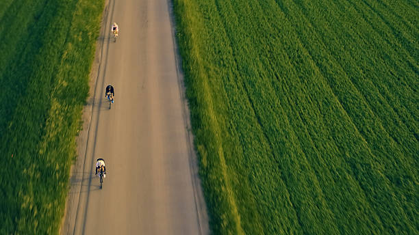 istock Four Cyclists Race on a Straight Road 2217427628