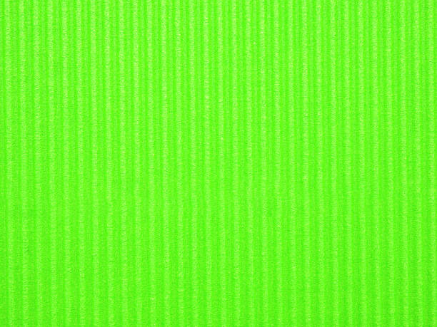 istock Top view, blank textured, vibrant lime green corrugated cardboard surface. The distinct parallel ridges and grooves run vertically across the frame. Concept for design, image, text, and banner. 2217427979