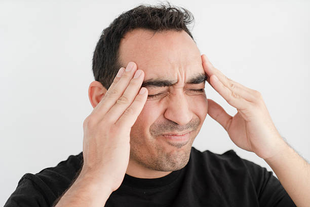 istock Young man holding his head out of headache 2217429050