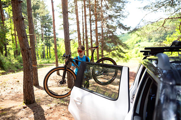 istock Young man preparing for mountain biking in a forested outdoor area 2217429439