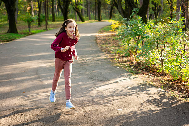 Carefree child girl running in park