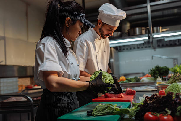 istock Chefs preparing food in a professional kitchen 2217431143