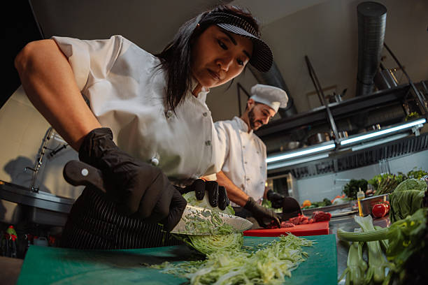 istock Professional chefs slicing fresh vegetables in a commercial kitchen 2217431152