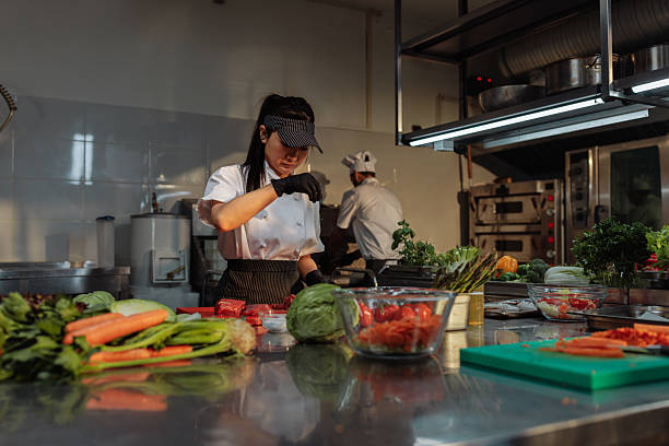 istock Professional chef seasoning meat in a commercial kitchen 2217431170