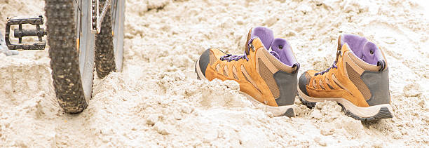 A lot of footprints in a sandy beach.