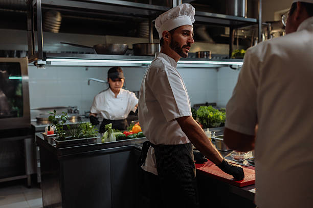 istock Chefs preparing food in a professional kitchen 2217431682