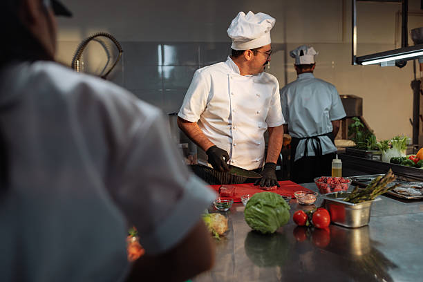 istock Chef preparing meat with knife in a commercial kitchen 2217431684