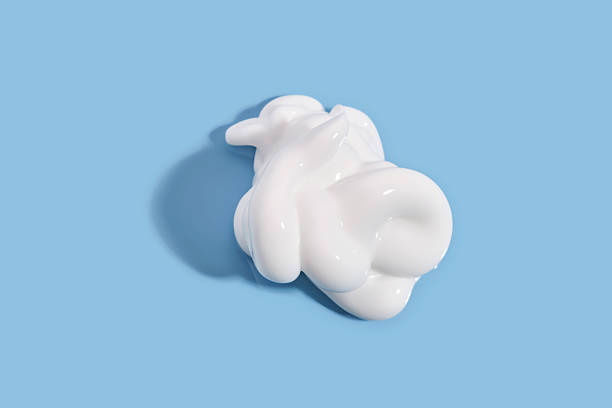 istock The texture of white cream on a blue background. 2217431782