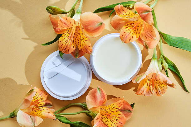 istock Cleansing hydrophilic balm or butter on a beige background with flowers. 2217433098