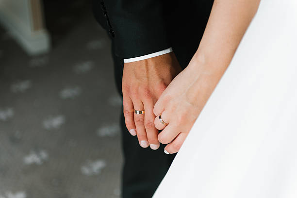 istock Bride And Groom Holding Hands 2217433945