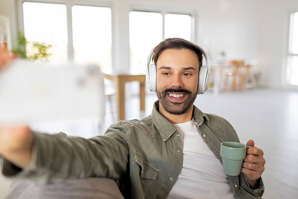 istock Trendy Guy Enjoying Selfie Time with Headphones On 2217433987