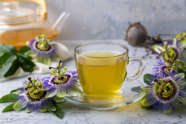 istock Cup of herbal tea with passiflora caerulea plant on white background. Alternative herb medicine, sedative and calming effect 2217434067