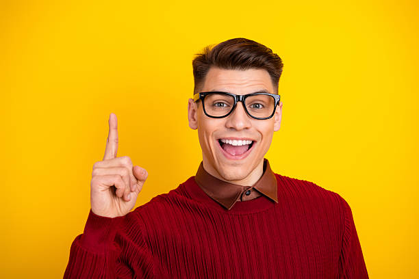 istock Cheerful Man in Casual Sweater Gesturing on Bright Yellow Background 2217434266