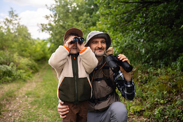 istock Father and son birdwatching together in a forest setting 2217434400
