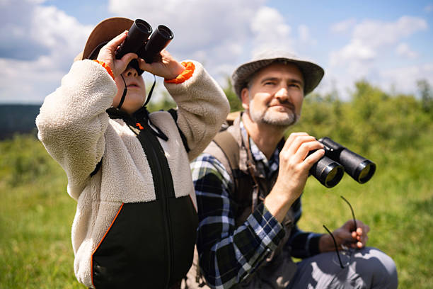 istock Father and son birdwatching in a scenic outdoor environment 2217434729
