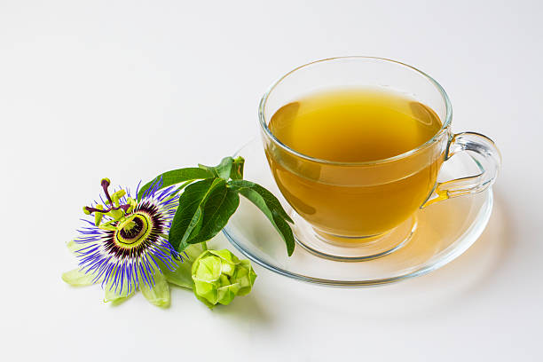 istock Cup of herbal tea with passiflora caerulea plant on white background. Alternative herb medicine, sedative and calming effect 2217436464