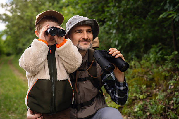 istock Father and son enjoying birdwatching together in a peaceful natural setting 2217436753