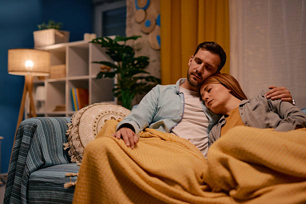 istock Loving couple sleeping together on the sofa under a blanket 2217440689