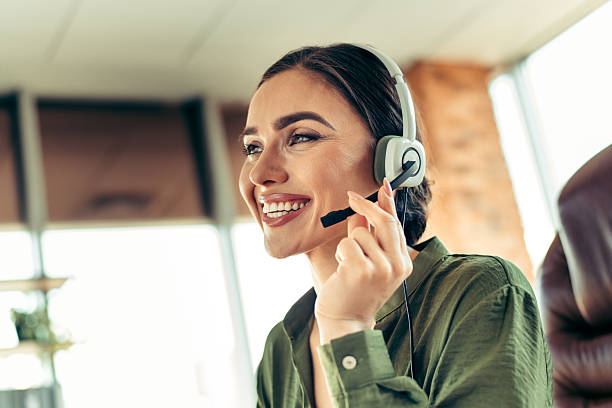 istock Professional woman wearing a headset while working in a modern office environment, showcasing confidence and dedication 2217440720