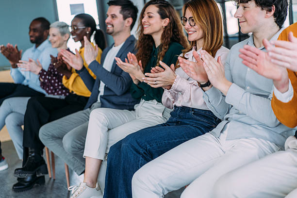 istock Businesspeople applauding during a seminar in conference hall. 2217443168