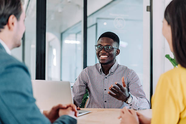 istock Group of business persons talking in the office. 2217445112
