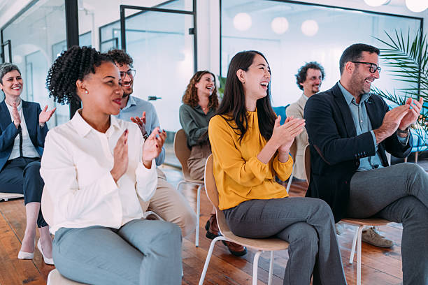 istock Businesspeople applauding during a seminar in conference hall. 2217445118