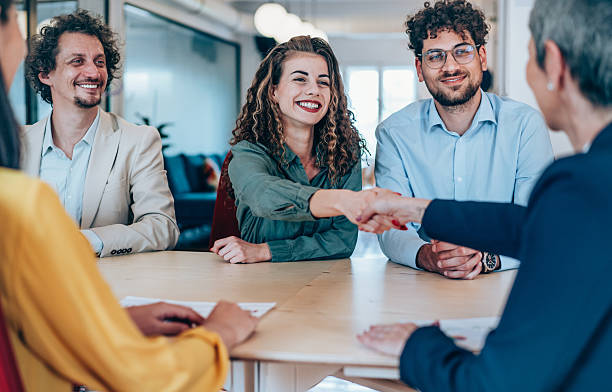 istock Businesswomen shaking hands across the table. 2217445136