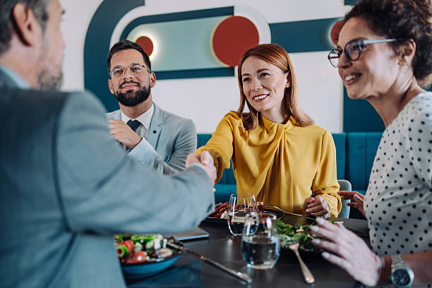 istock Businesspeople shaking hands at the restaurant. 2217445928