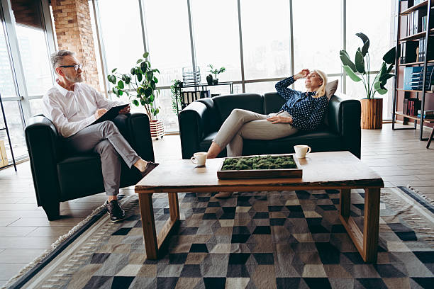 istock Professional counseling session in a modern office space featuring a mature man consulting with a senior woman 2217446225