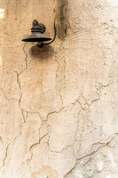 istock vintage wall with antique lamp, blank space for text or content I Premium wall with cracks background hi-res stock image 2217446515