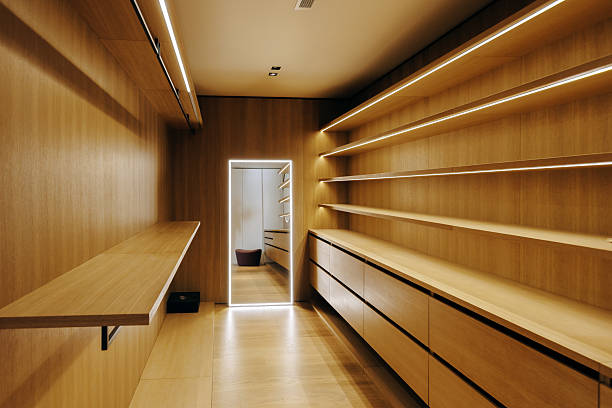 istock A spacious walkin closet featuring wooden shelves and convenient drawers 2217458629