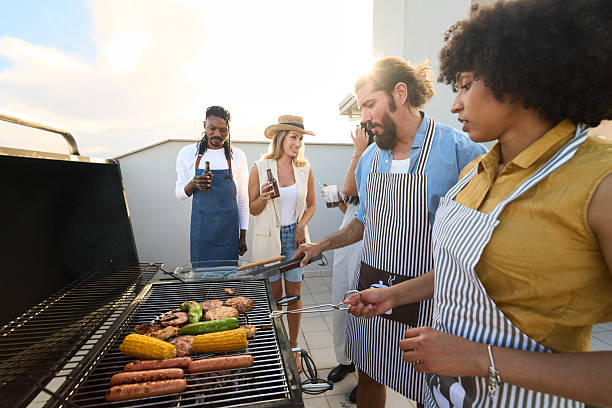 istock Friends grilling food and having drinks on rooftop terrace 2217458816