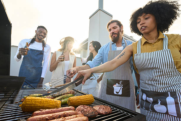 istock Friends grilling food and having drinks on rooftop terrace 2217458826
