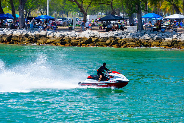 Miami Beach, FL, USA - May 25, 2025: Man riding a waverunner in Miami going through the Haulover Inlet