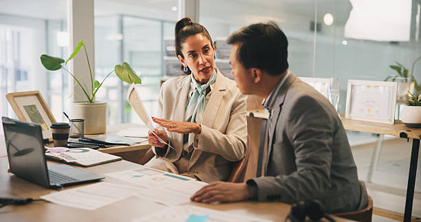 istock Collaboration, documents and meeting with business people in office for development or discussion. Laptop, paper and planning with employee team in corporate workplace for conversation or strategy 2217463875