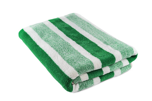 istock Carefully folded soft striped bath green towel isolated on white background 2217467898