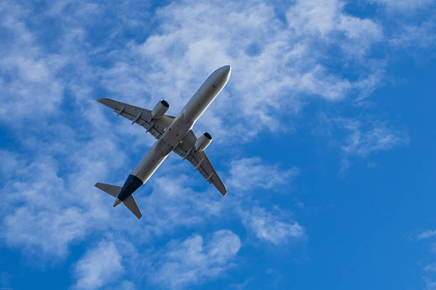 istock Passenger airplane flying in cloudy sky 2217472536