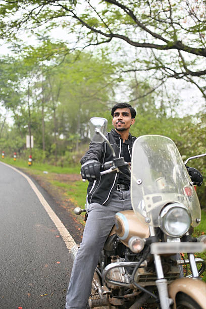 istock Young man on a motorcycle  on a scenic countryside road 2217472887