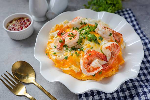 istock Thai style scrambled eggs with shrimps on rice, creamy omelet with shrimps on rice 2217473753