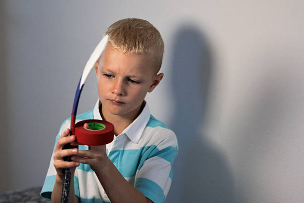 Boy with ice hockey stick on a white background