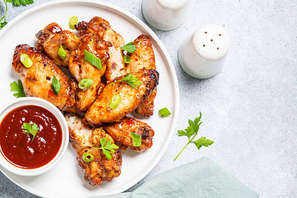 istock Chicken wings in bbq sauce at white table. 2217480799