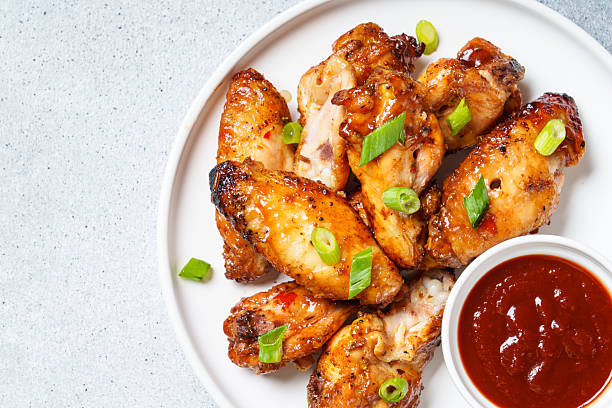 istock Chicken wings in bbq sauce at white table. 2217480801