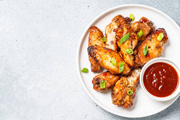 istock Chicken wings in bbq sauce at white table. 2217480818