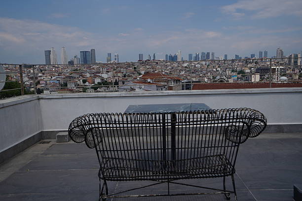 Rooftop Terrace with Panoramic City View and Iron Bench