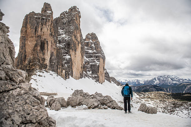 The hiker is posing in front of the Tahtalı Mount (2365 m.) in winter time in Antalya, Turkey