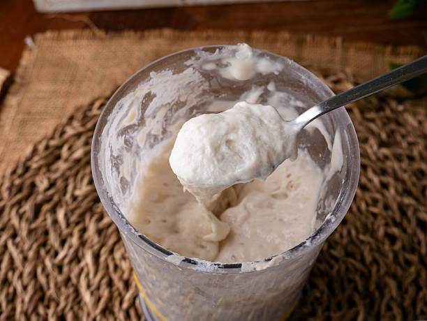 istock Bubbly sourdough starter in glass jar. Active yeast for bread making 2217484335
