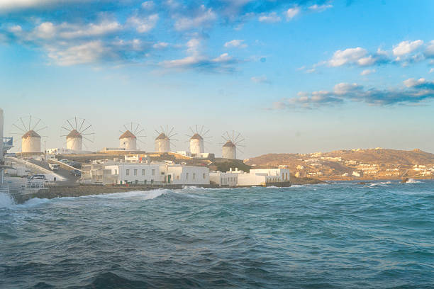 famous windmill of Mykonos island and The Town over seascape, Mykonos island, Greece