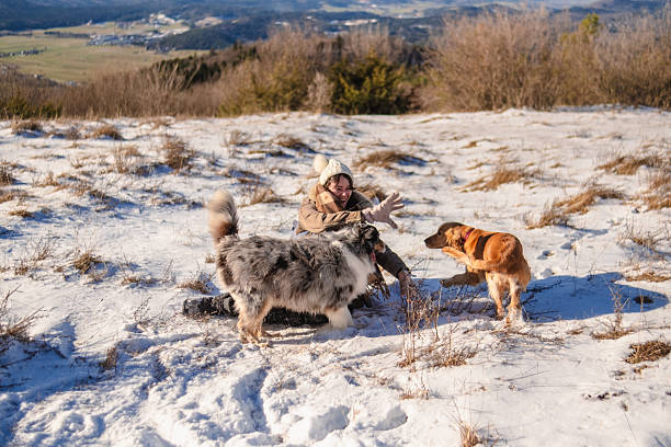 Woman having a blast with her dog on a Winter vacation