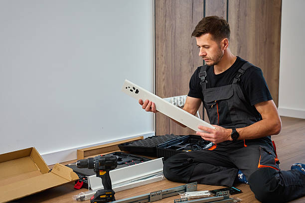 istock Man assembling furniture at home, preparing cabinet components 2217485728